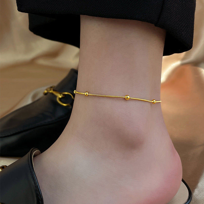 Tobillera en color oro – cadena de bolitas